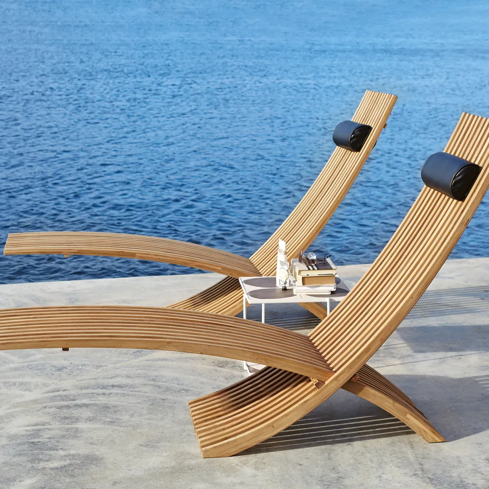 Nozib lounge chair, Teak, black neck rest in leather Skargaarden