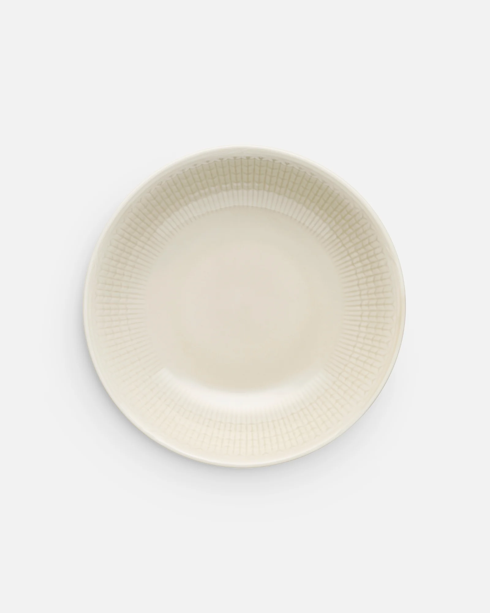 An off-white shallow oval dish with a subtle textured grid pattern on the rim, viewed from above.