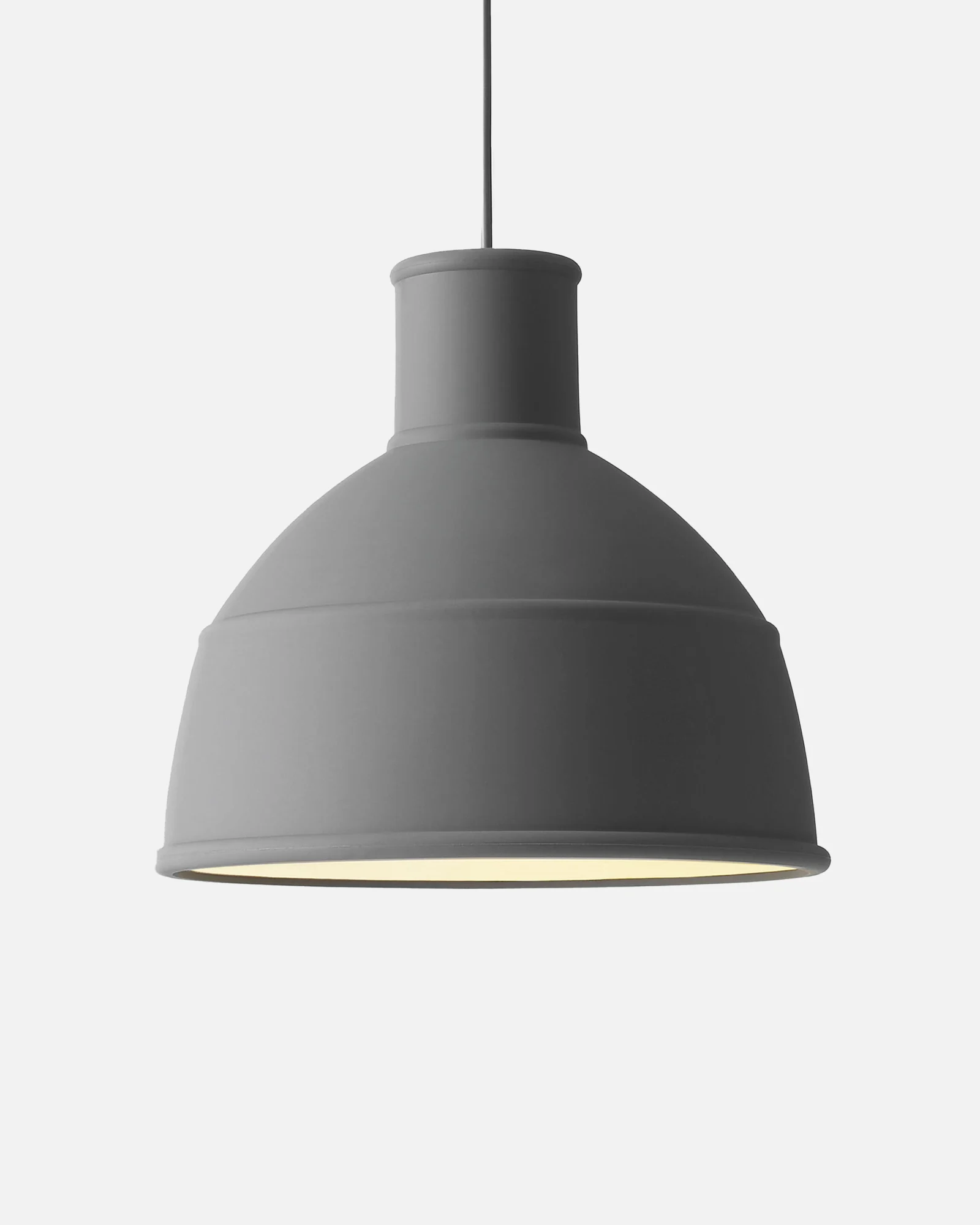 Gray bell-shaped pendant lamp, emitting a soft light from within, hanging from a cord.