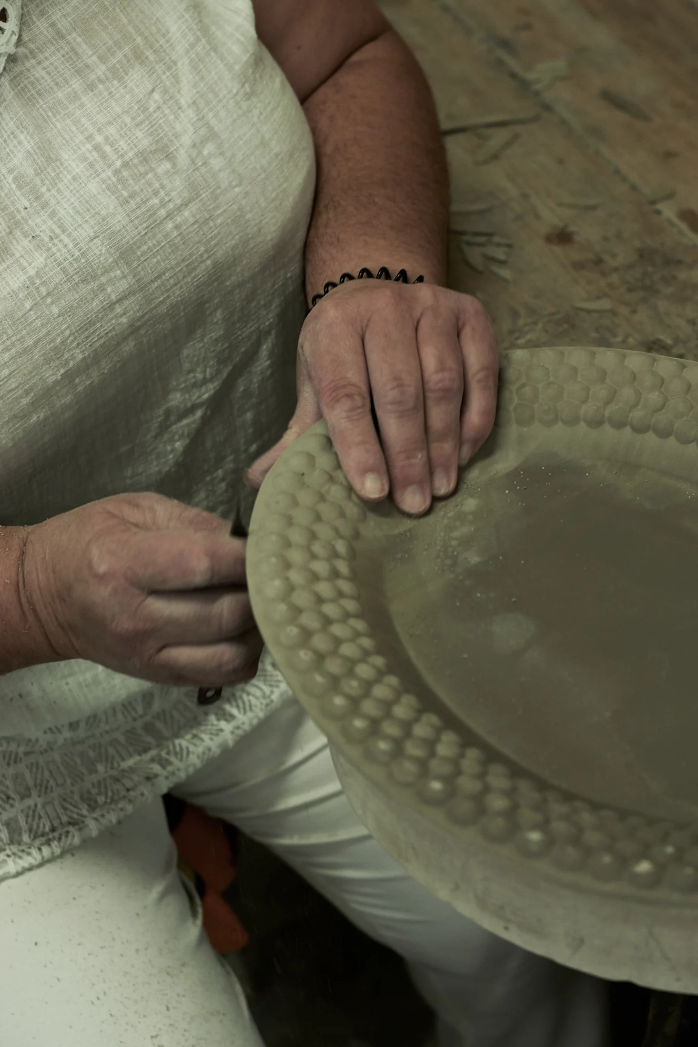 The excess clay is then removed from the product.
