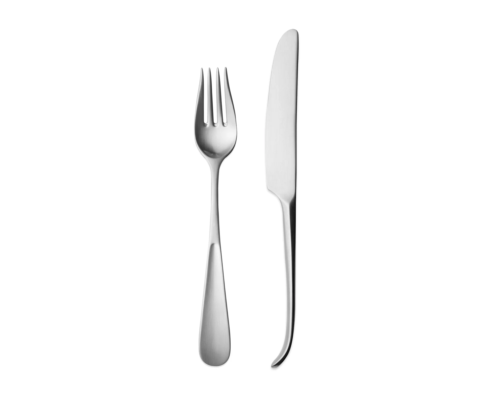 A shiny silver fork with four tines stands upright next to a sleek silver knife with a subtly curved handle.