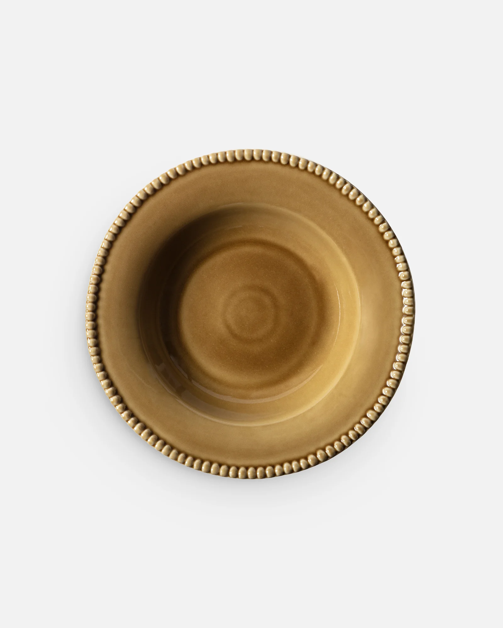 A round, mustard yellow ceramic bowl with a decorative beaded rim, centered on a white background.