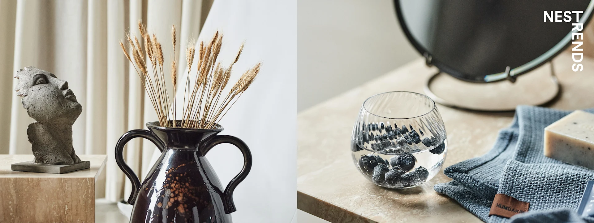 Left: Grey bust, brown vase with dried wheat. Right: Glass with blueberries, grey towel, bar of soap.