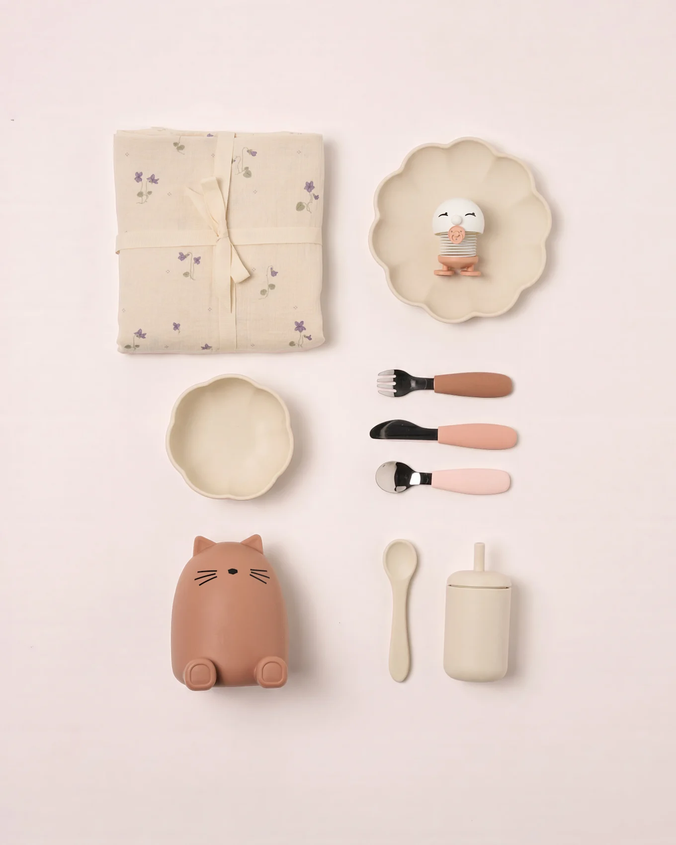 Baby set: floral blanket, scalloped plate with bird toy, bowl, cat container, cutlery, spoon, and lidded cup.