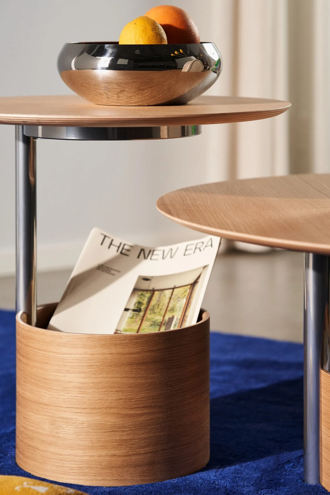 A close up of the base of the Parasol table from Maze used for storage of magazines.