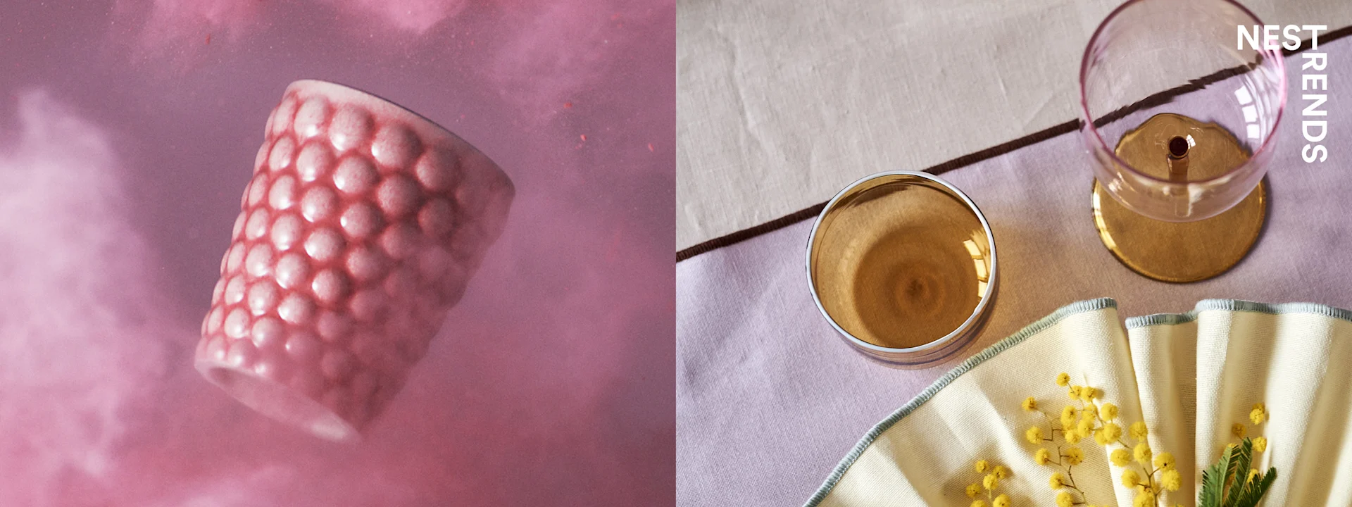A pink textured cup floats in pink powder, next to a table setting with mimosa flowers and glassware.