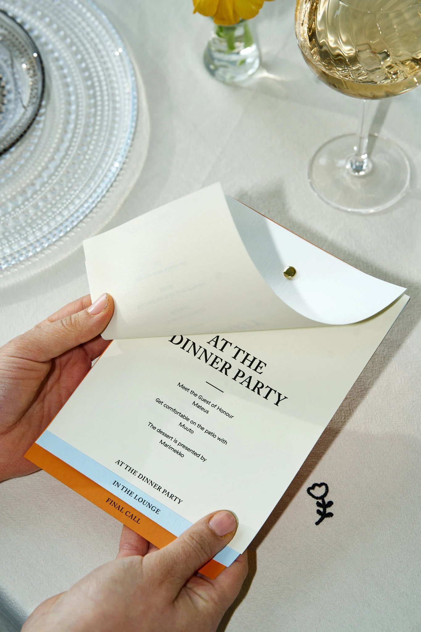 Discover how to throw a party here you see a pair of hands holding a card highlight the schedule for the party. 