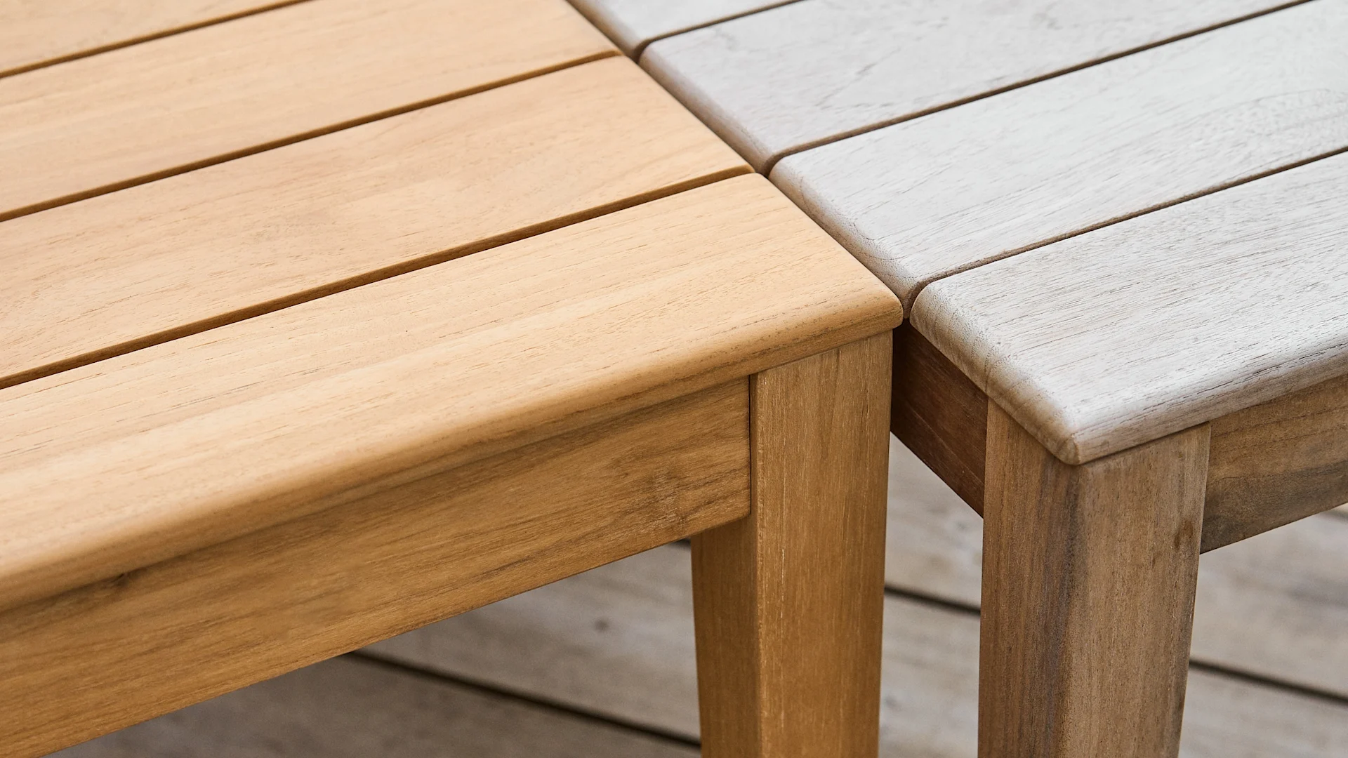 Two wooden table sections, one natural light brown and one weathered light gray, meeting at a corner.
