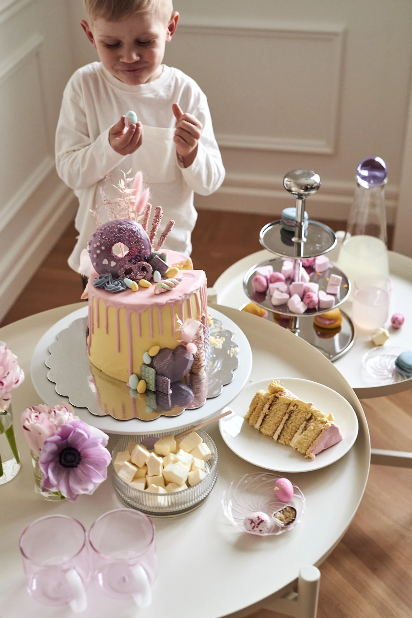 An Easter dessert table is a great idea for a colourful and fun Easter table setting. Here you see a young boy enjoying a piece of cake.