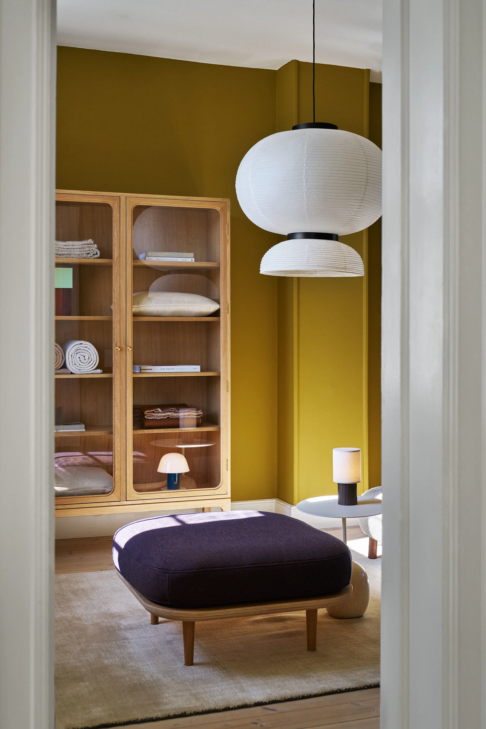Here you see a bright yellow with a number of products from &Tradition including the Formakami lamp and the Manhattan portable table lamp.