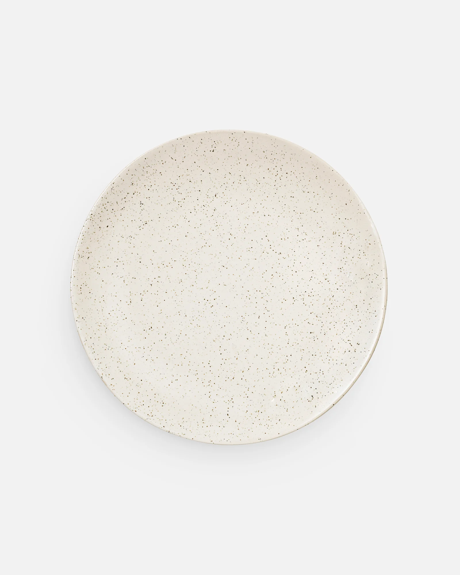 A cream-colored, round plate with dark speckles.