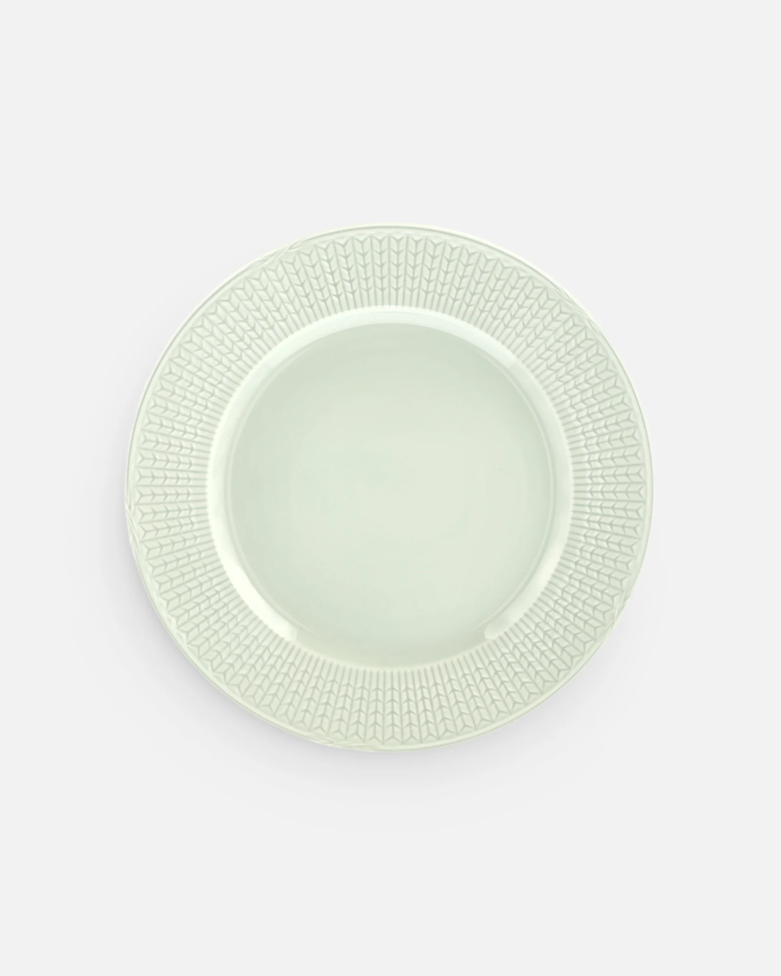 Light green round plate with a textured, patterned rim.