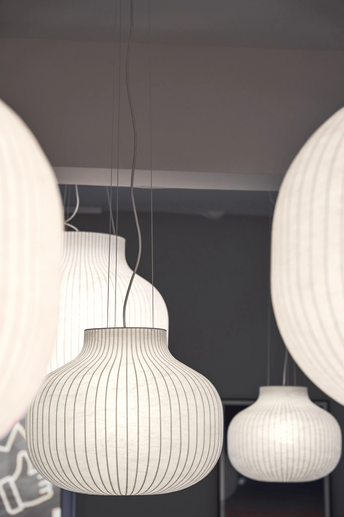 Several Strand pendant lights from Muuto hang from the ceiling.
