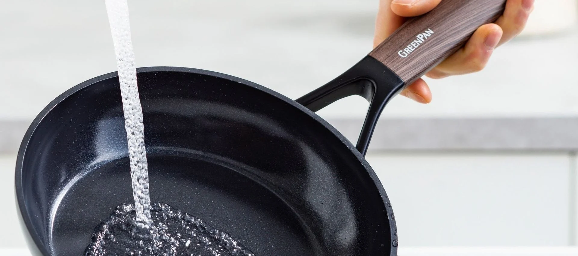 Clean pans such as the Eco Smartshape pan from Greenpan under running water.