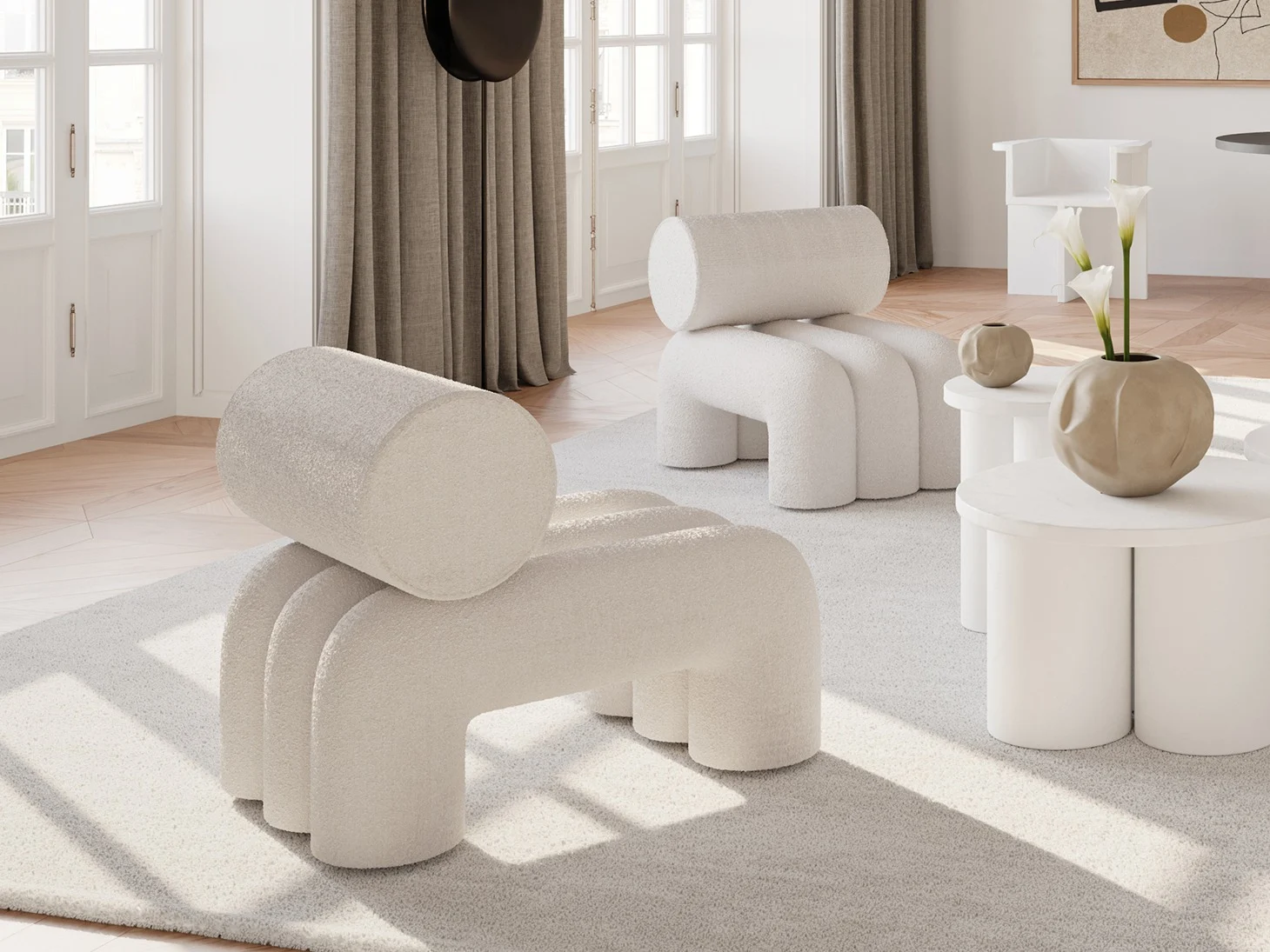 Two off-white, textured, minimalist chairs with cylindrical backs and arched legs in a modern living room.