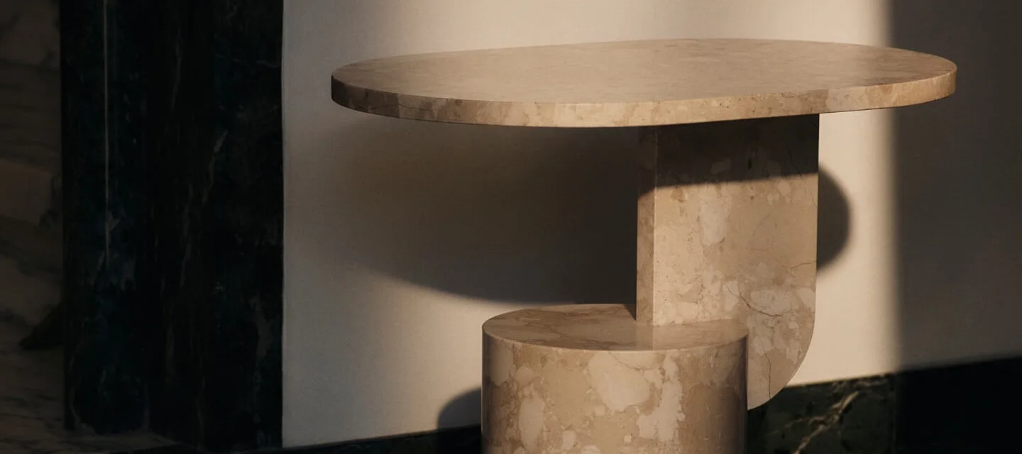 Oval side table made of light marble, featuring a sculptural base of rectangular and cylindrical forms.
