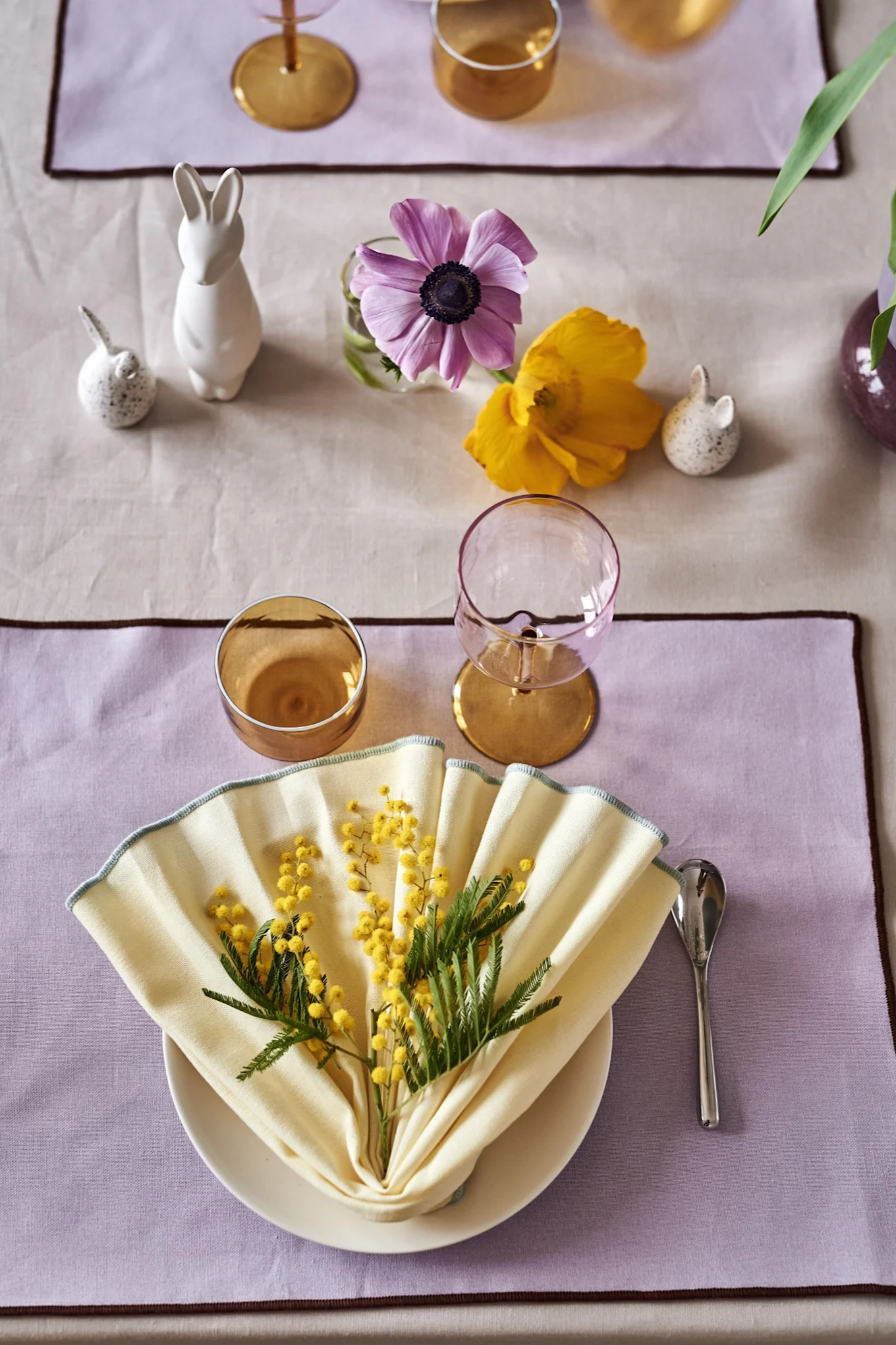 Your Easter table setting ideas should always include a napkin fold like the one you see here in tones of yellow.