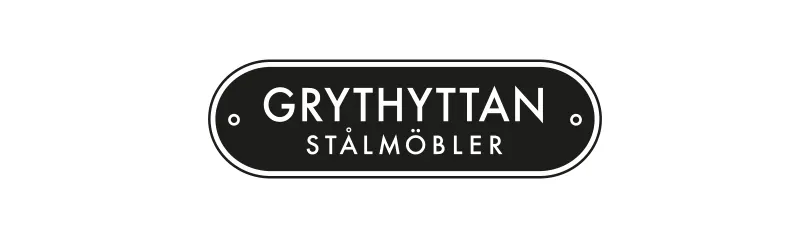 Dark gray oval label with white text 'GRYTHYTTAN STÅLMÖBLER' (Grythyttan Steel Furniture).